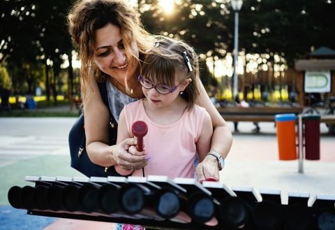 Woman and female child playing the xylophone