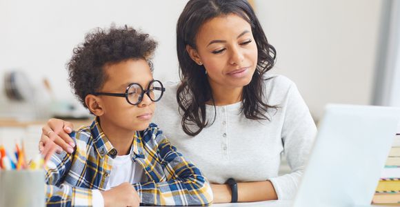 Teacher and child with computer