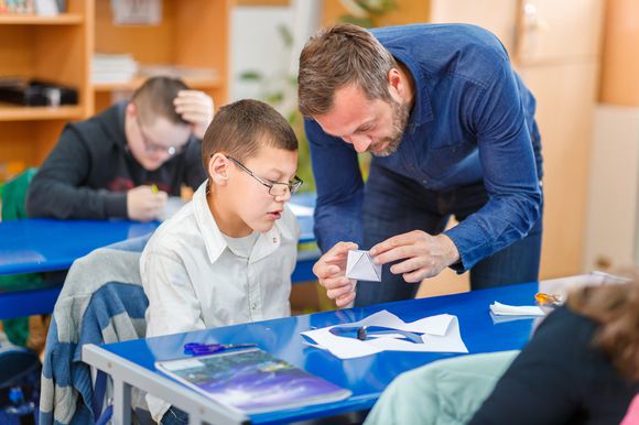 Male student and teacher in classroom